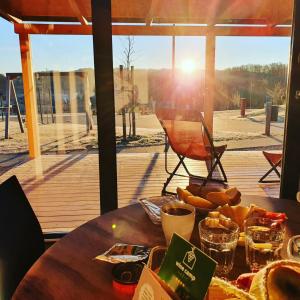 a table with food on it with a view of a deck at Wine Camp Hažić in Sveti Martin na Muri