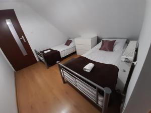 a small bedroom with a bed and a mattress at Sarzynówka in Krasnobród