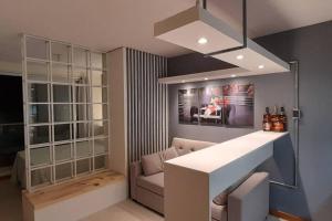 a kitchen with a table and a couch and a chandelier at Mónaco in Montevideo