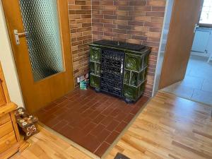 a brick wall with a stove in a room with a door at Ferienhaus Marchhäuser 12 in Haidmühle