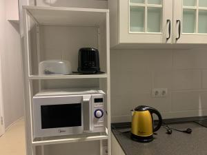 a microwave on a shelf in a kitchen at O'Key Home in Rostov on Don