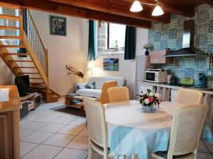 cocina y sala de estar con mesa y sillas en Gîte Atypique Dans Une Chapelle en Briec