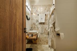 a bathroom with a sink and a shower with a sink at Hotel Alfréd a Hermína in Olomouc