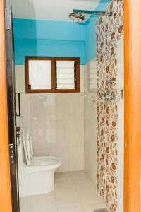 a bathroom with a toilet and a shower curtain at Nagarkot Nayagaun Homestay in Nagarkot