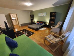 a living room with a bed and a couch at Casa Corona in Braşov