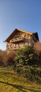 a house sitting on top of a hill at Uptown Apartments Interlaken free Parking in Interlaken