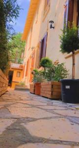 a building with potted plants on the side of it at RENT APPART - La Garenne Colombes in La Garenne-Colombes