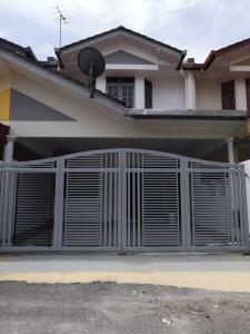 a house with a gate in front of it at The Pigeon Alor Akar Guest House in Kuantan