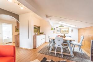 a kitchen and living room with a table and chairs at Zinsers Bergliebe in Inzell