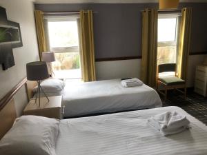 Ένα ή περισσότερα κρεβάτια σε δωμάτιο στο Boathouse Hotel