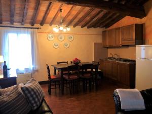 een keuken en eetkamer met een tafel en stoelen bij Villa Cenerentola in Trequanda