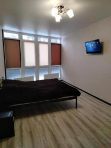 una camera con un letto in una stanza con finestre di Квартира в ЖК Атриум a Irpin'