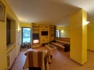 a large living room with a couch and a fireplace at HOTEL B&B RESORT Fonte La Castellana in Sarnano