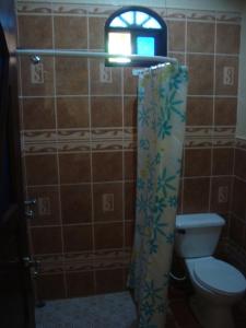 a bathroom with a toilet and a window at Ecolodge Blue Morpho in Cárdenas