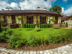 a house with a green yard in front of it at Petrani Central in Kyiv