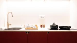 a kitchen counter with a sink and some pots and pans at La Vacanza Ortigia in Siracusa +217 photos