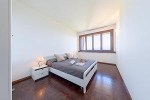 Posteľ alebo postele v izbe v ubytovaní Ferrari 13 Apartment by Wonderful Italy + 10 fotografií