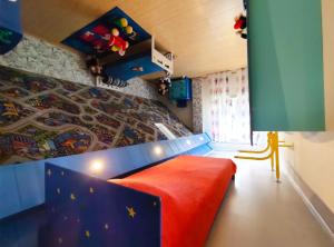 a room with a bed and a mural on the wall at Night in Upsidedown House in Petrovo
