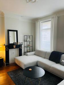 a living room with a couch and a table at O-Sea House: herenwoning in Belle Epoque wijk te Oostende in Ostend