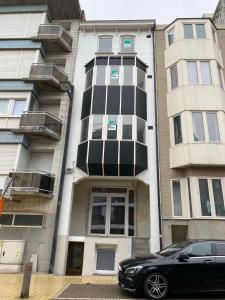 a black car parked in front of a building at ChezPetitOscar in Middelkerke