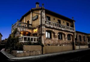 an old building with a man on top of it at Casa Rural del Médico in Hontoria del Pinar