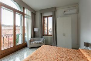a bedroom with a bed and a large window at Canaletto Apartments in Venice