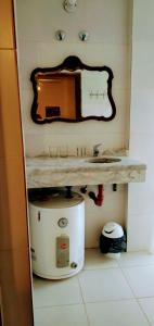 a bathroom with a sink and a mirror on the wall at Departamento Yokavil in Santa María