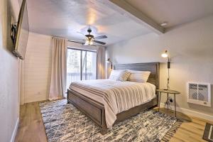 a bedroom with a bed with a ceiling fan and a window at Brian Head Condo Near Lifts at Giant Steps! in Brian Head
