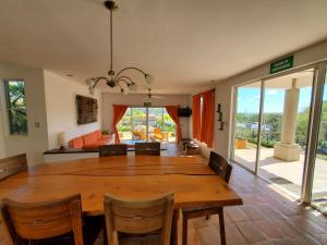 una sala da pranzo con un grande tavolo in legno e sedie di Bahia Del Sol Villas & Condominiums a San Juan del Sur