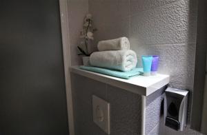 a bathroom with towels on a counter in a bathroom at Apartments Adria in Baška Voda