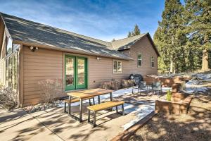a house with a picnic table in front of it at Woodland Park Hideaway with Mtn Views and Hot Tub in Woodland Park