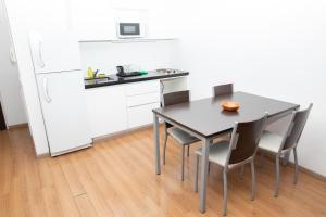 a kitchen with a table and chairs and a refrigerator at BriDan in Rosario