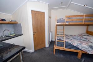 a small room with a bunk bed and a sink at Seaways glamping, Silverbirch in Great Driffield