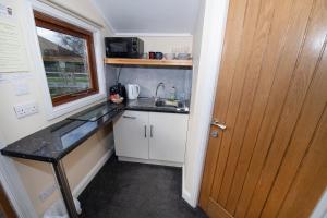 a small kitchen with a sink and a window at Seaways glamping, Silverbirch in Great Driffield