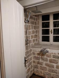 a bathroom with a shower in a brick wall at Soul boutique hotel in Monodendri