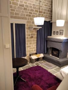 a living room with a fireplace and a table at Soul boutique hotel in Monodendri