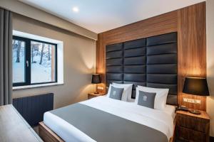 Ένα ή περισσότερα κρεβάτια σε δωμάτιο στο Bristol Hotel and Spa Bakuriani