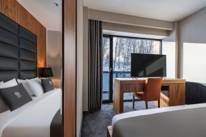 Ένα ή περισσότερα κρεβάτια σε δωμάτιο στο Bristol Hotel and Spa Bakuriani