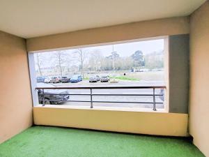 una ventana en una habitación con vistas a un aparcamiento en Standing appartement avec vue sur la Mayenne en Laval