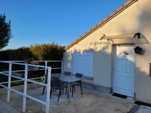 a patio with a table and chairs next to a building at le studio in Chouilly