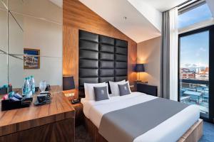 Ένα ή περισσότερα κρεβάτια σε δωμάτιο στο Bristol Hotel and Spa Bakuriani