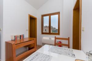 a room with a table and a desk and a desk and chair at MODERN APARTMENT WITH SEA VIEW in Dubrovnik