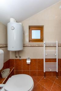 a bathroom with a toilet and a window at MODERN APARTMENT WITH SEA VIEW in Dubrovnik