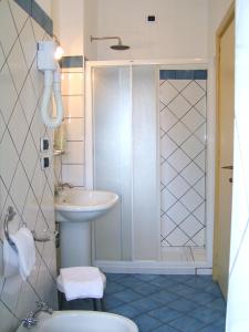 a bathroom with a toilet and a sink and a shower at Stromboli Central Family Apartment - 3 Double Rooms in Stromboli
