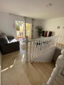 a white staircase in a living room with a couch at Caleta Sunset in Caleta De Fuste
