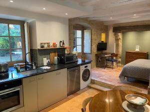 a kitchen with a sink and a table in a room at Clos Saint Léonard in Durtal
