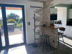 a kitchen with a table and chairs and a fireplace at Villa Ghjuvan - Sea, Mountain & Spa in Peri