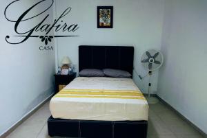 a bedroom with a bed in a room with a fan at Casa Glafira in Oaxaca City