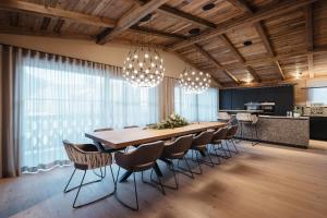 a large dining room with a long table and chairs at Pescosta Chalet Luxury Living in San Vigilio Di Marebbe