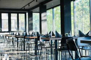 a row of tables and chairs with laptops on them at Hotel Costa Verde in Milano Marittima +21 photos